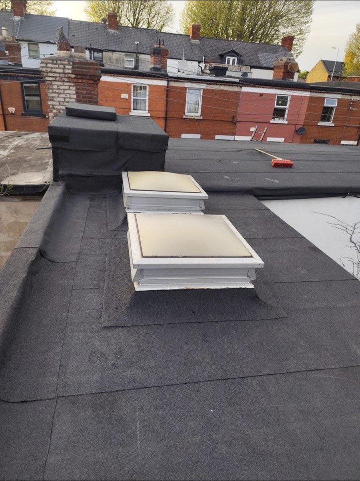 Flat roof with skylights and weatherproofed chimney detail