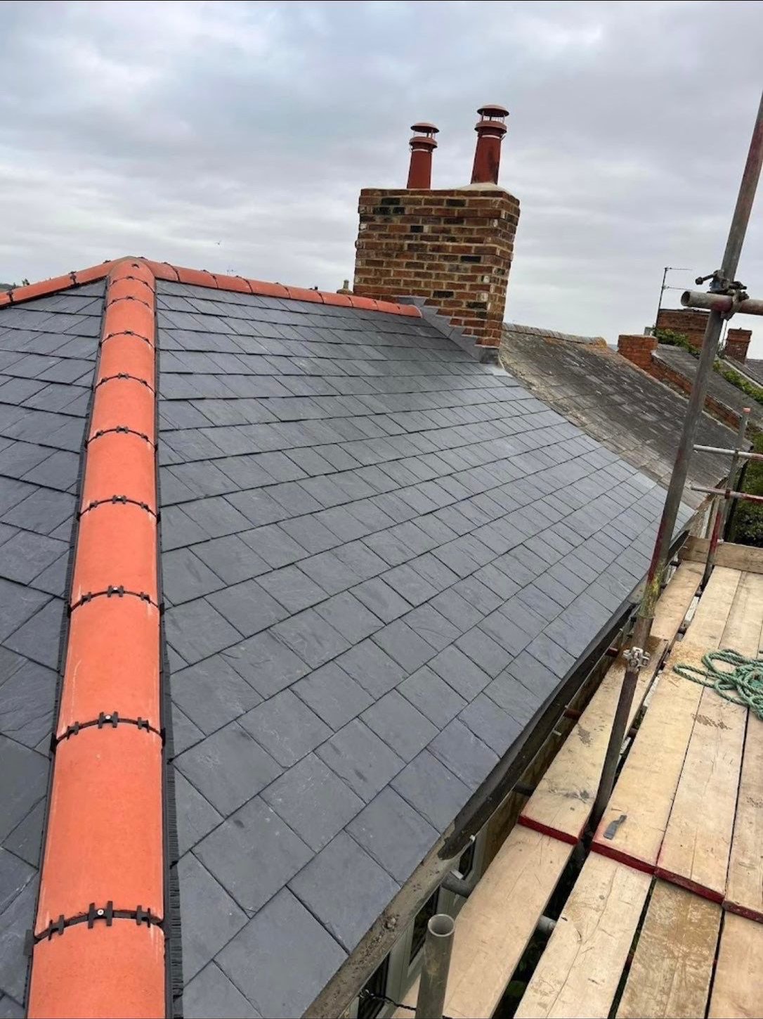 Finished slate roof with clean terracotta ridge detail